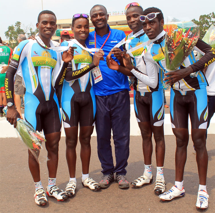 Team Rwanda riders pose for a photo with their coach Sempoma Felix
